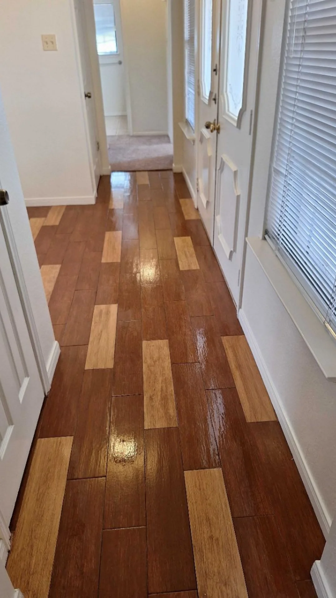 A polished entry hallway with wood tile floors maintained by professional janitorial services in Georgetown.