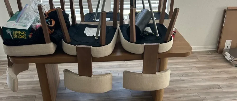 Dining chairs inverted on a wooden table during a move in move out cleaning in Temple, TX.